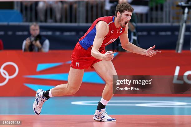 Maxim Mikhaylov of Russia celebrates after a point against Brazil during the Men's Volleyball gold medal match on Day 16 of the London 2012 Olympic...