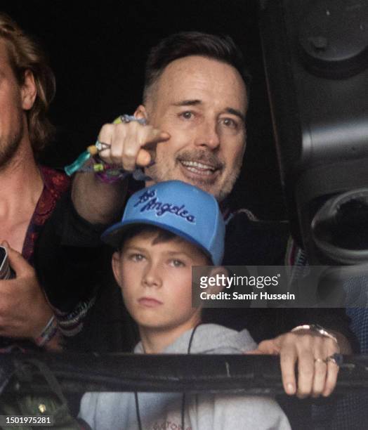 David Furnish and son watch Elton John perform on the Pyramid stage at Day 5 of Glastonbury Festival 2023 on June 25, 2023 in Somerset, United...