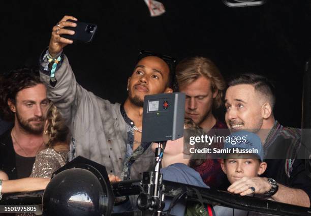 Aaron Taylor-Johnson, Lewis Hamilton and David Furnish with his sons Zachary Furnish-John and Elijah Furnish-John watch Elton John perform at Day 5...