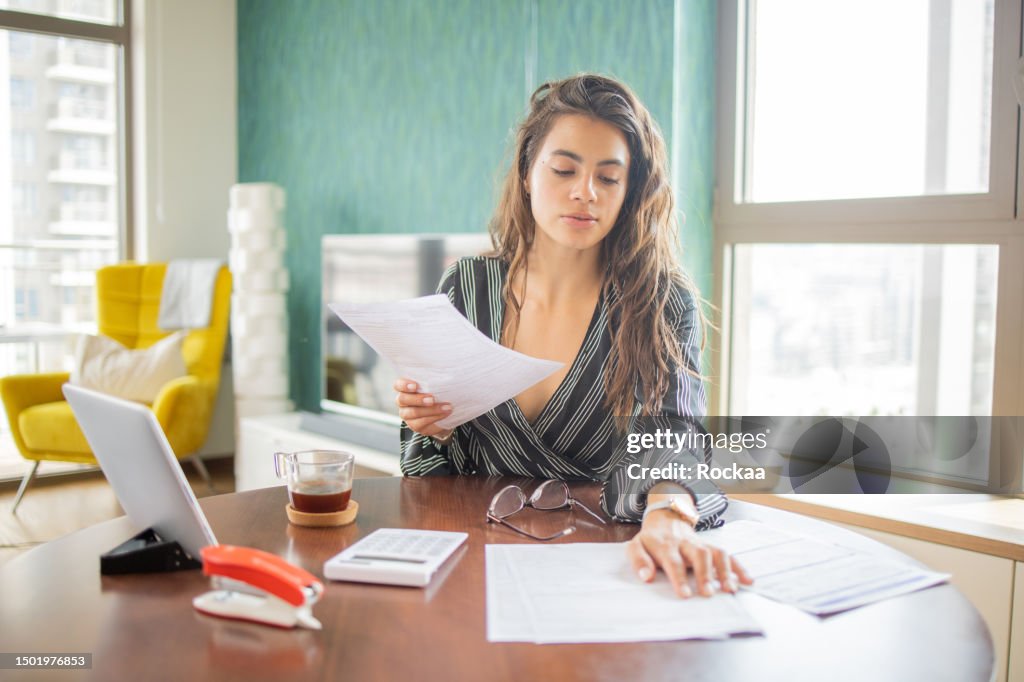 Success Through Paperwork Young Woman Going Through Paperwork High-Res Stock Photo - Getty Images