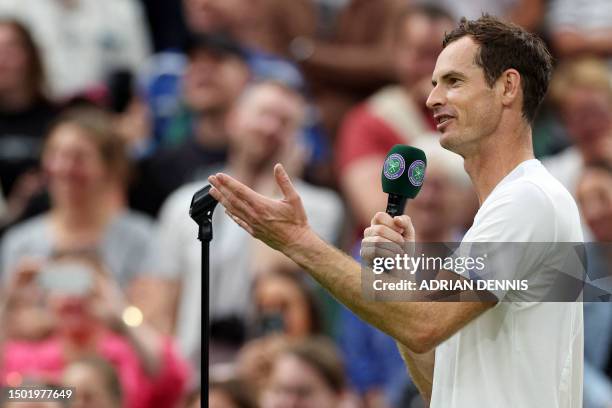 Britain's Andy Murray addresses Switzerland's former tennis player Roger Federer after winning his men's singles tennis match against Britain's Ryan...