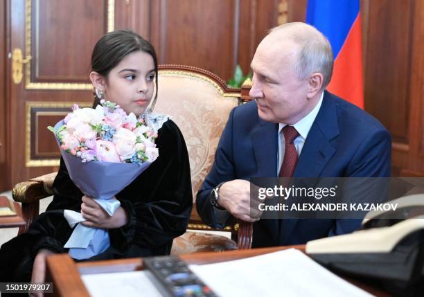 Russian President Vladimir Putin meets with Raisat Akipova, an 8-year-old girl from Derbent, who failed to see the head of state during his working...