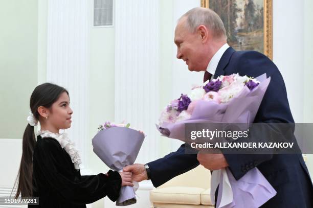 Russian President Vladimir Putin meets with Raisat Akipova, an 8-year-old girl from Derbent, who failed to see the head of state during his working...