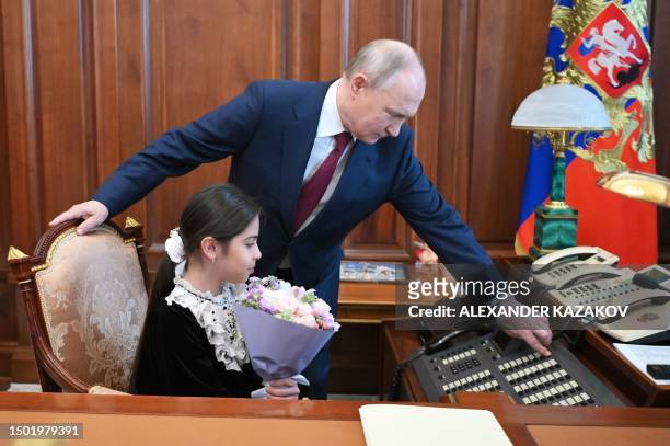 Russian President Vladimir Putin meets with Raisat Akipova, an 8-year-old girl from Derbent, who failed to see the head of state during his working...