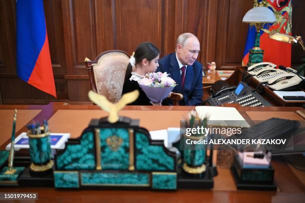 Russian President Vladimir Putin meets with Raisat Akipova, an 8-year-old girl from Derbent, who failed to see the head of state during his working...