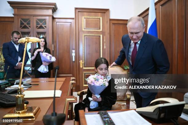 Russian President Vladimir Putin meets with Raisat Akipova, an 8-year-old girl from Derbent, who failed to see the head of state during his working...