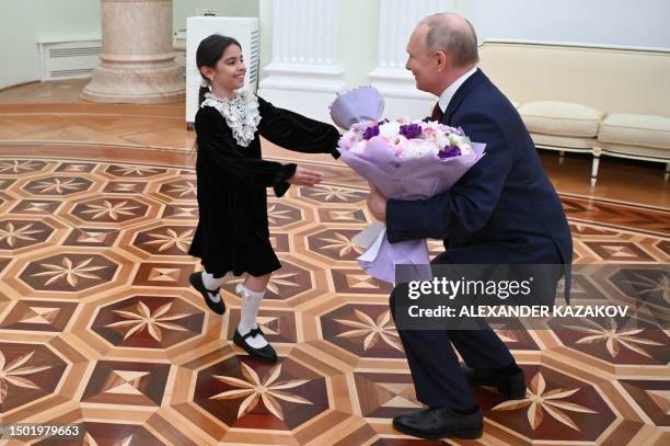 Russian President Vladimir Putin meets with Raisat Akipova, an 8-year-old girl from Derbent, who failed to see the head of state during his working...