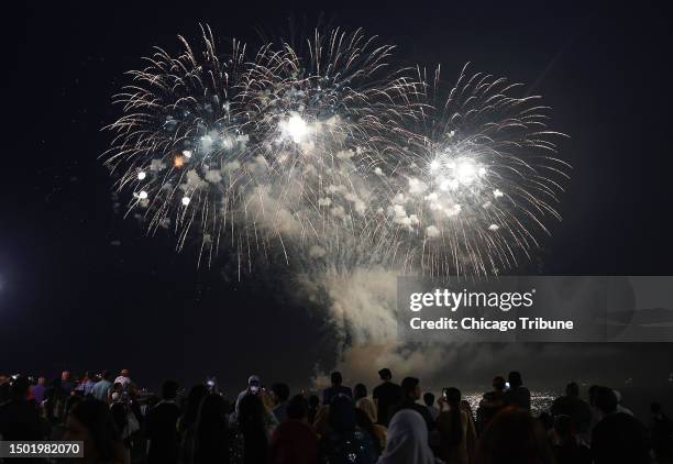 People watch from Navy Pier in Chicago as fireworks are set off on July 1 to celebrate the Fourth of July weekend.