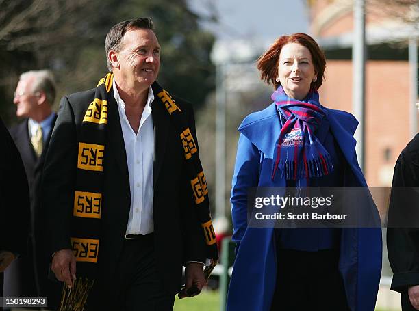Australian Prime Minister Julia Gillard and her partner Tim Mathieson walk to an Australian Rules football game after launching the Korin Gamadji...