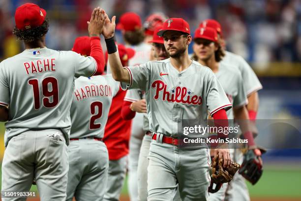 Trea Turner of the Philadelphia Phillies high fives Cristian Pache after beating the Tampa Bay Rays at Tropicana Field on July 4, 2023 in St...