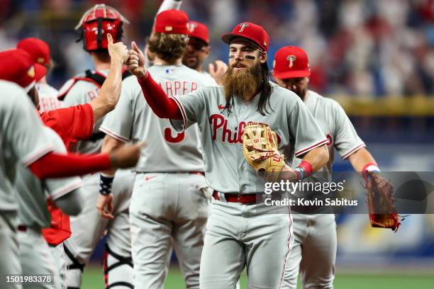 Brandon Marsh of the Philadelphia Phillies high fives teammates after beating the Tampa Bay Rays at Tropicana Field on July 4, 2023 in St Petersburg,...