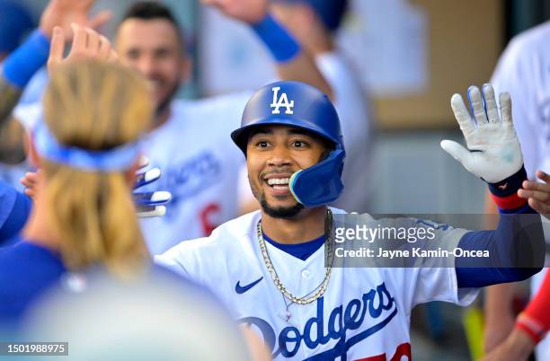Mookie Betts of the Los Angeles Dodgers is greeted in the dugout after hitting a solo home run in the second inning against the Pittsburgh Pirates at...
