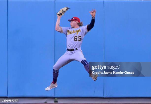 Jack Suwinski of the Pittsburgh Pirates makes a catch at the wall in the third inning against the Los Angeles Dodgers at Dodger Stadium on July 4,...