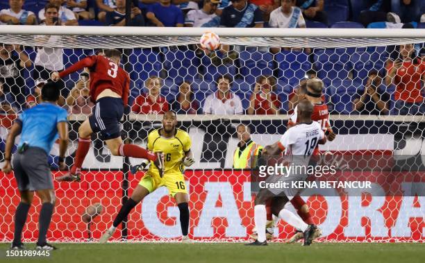 Costa Rica's defender Juan Pablo Vargas heads the ball and scores his team's third goal during the Concacaf 2023 Gold Cup Group C football match...