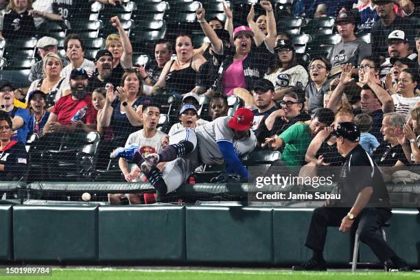 George Springer of the Toronto Blue Jays crashes into the netting in right field chasing down a triple hit by Tim Anderson of the Chicago White Sox...