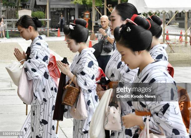 Wearing "yukata" summer kimonos, Geiko and Maiko pray at Yasaka shrine in Kyoto on July 5 for health and improvement in their performances.