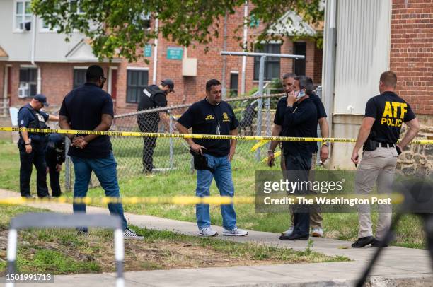 Authorities search for evidence at the scene of last nights mass shooting that left 2 dead and 20 wounded in Baltimore, MD.