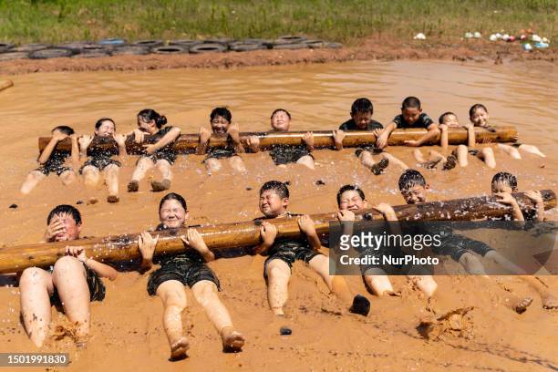 Children are training during the ''Tactical Quagmire'' program at a military summer camp in Hefei, Anhui Province, China on July 5, 2023.