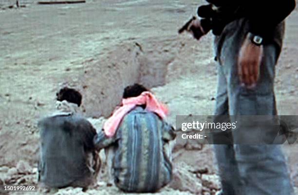 In this image taken from a video made available 04 October 2004, two blind folded hostages are seen moments before their execution at an unkown...