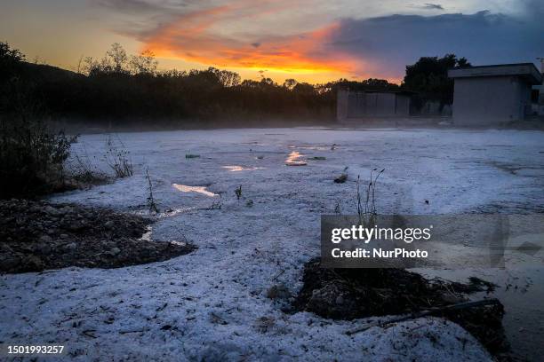 Stretch of hailstones is seen at sunset after a huge hail storm in L'Aquila, Italy, on July 4, 2023.