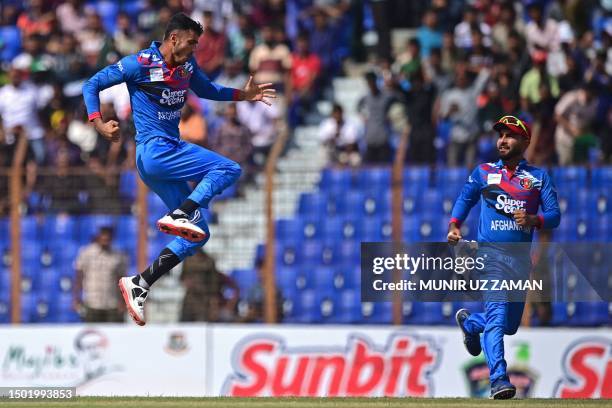 Afghanistan's Mujeeb Ur Rahman celebrates after taking the wicket of Bangladesh's Liton Das during the first one-day international cricket match...