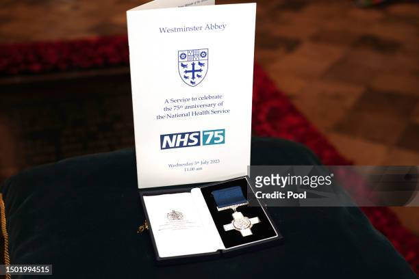 The Order of Service and the George Cross which was presented to the National Health Service on show at the NHS anniversary ceremony as part of the...