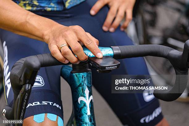 Rider adjusts his Garmin cycling computer and GPS as he awaits the start of the 5th stage of the 110th edition of the Tour de France cycling race,...