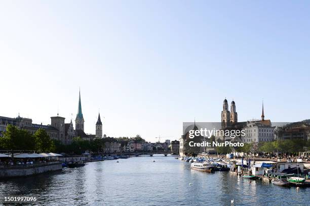 View Zurichs most emblematic churches on each side of the Limmat river on JULY 4 in Zurich, Switzerland.