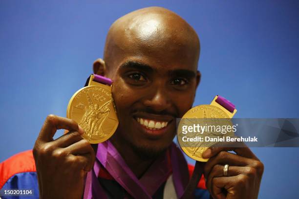 Gold medalist Mohamed Farah of Great Britain poses with his medals for the 10,000m and 5000m as he attends a TEAM GB Press Conference during Day 16...