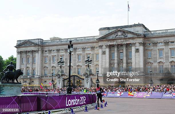 Wilson Kipsang Kiprotich of Kenya backdropped by Buckingham Palace competes in the Men's Marathon on Day 16 of the London 2012 Olympic Games on the...