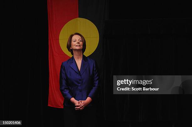 Australian Prime Minister Julia Gillard stands in front of the Aboriginal flag as she launches the Korin Gamadji Institute at the ME Bank Centre on...