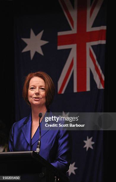 Australian Prime Minister Julia Gillard stands in front of the Australian flag as she speaks at the launch the Korin Gamadji Institute at the ME Bank...