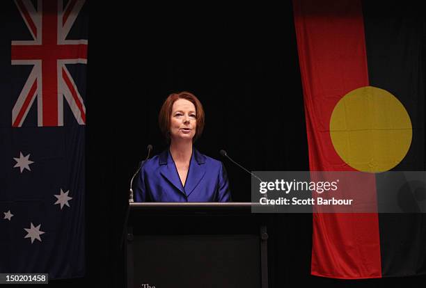 Australian Prime Minister Julia Gillard stands in front of the Australian and Aboriginal flags as she speaks at the launch the Korin Gamadji...