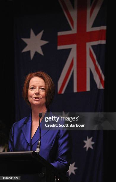 Australian Prime Minister Julia Gillard stands in front of the Australian flag as she speaks at the launch the Korin Gamadji Institute at the ME Bank...