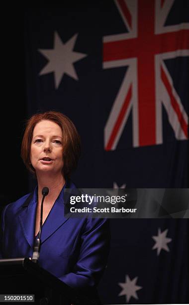 Australian Prime Minister Julia Gillard stands in front of the Australian flag as she speaks at the launch the Korin Gamadji Institute at the ME Bank...