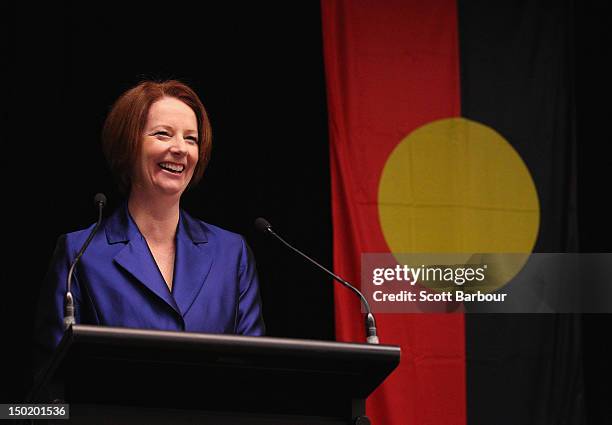 Australian Prime Minister Julia Gillard stands in front of the Aboriginal flag as she launches the Korin Gamadji Institute at the ME Bank Centre on...