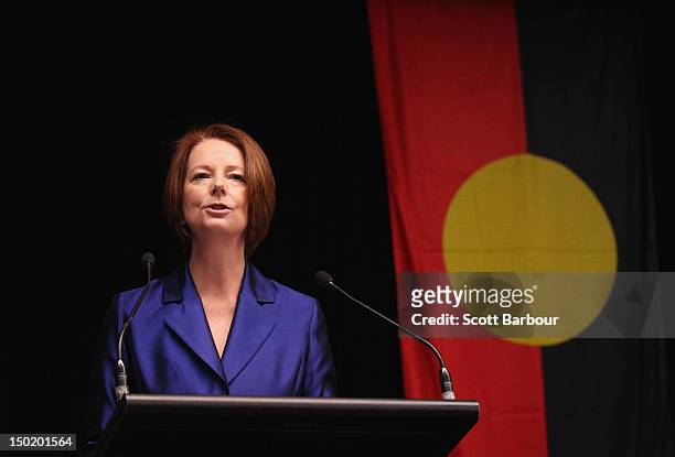 Australian Prime Minister Julia Gillard speaks in front of the Aboriginal flag as she launches the Korin Gamadji Institute at the ME Bank Centre on...