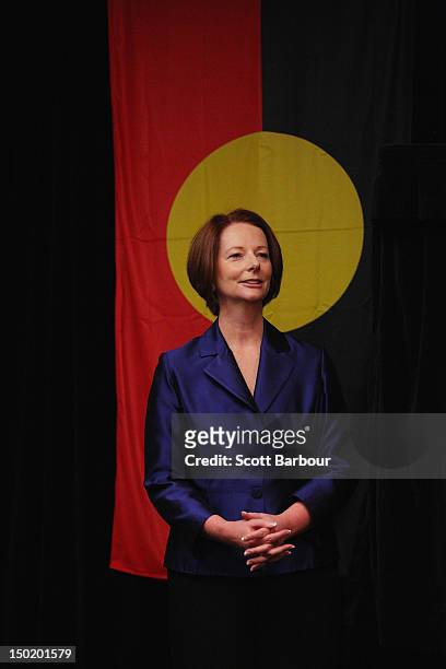 Australian Prime Minister Julia Gillard stands in front of the Aboriginal flag as she launches the Korin Gamadji Institute at the ME Bank Centre on...