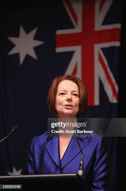 Australian Prime Minister Julia Gillard stands in front of the Australian flag as she speaks at the launch the Korin Gamadji Institute at the ME Bank...