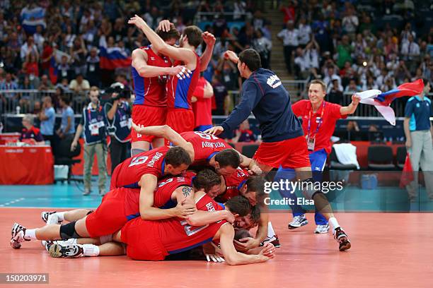 Russia celebrates after defeating Brazil in the fifth set of the Men's Volleyball gold medal match on Day 16 of the London 2012 Olympic Games at...