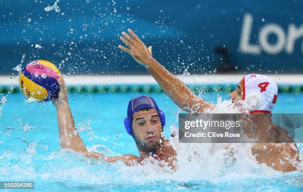 Vanja Udovicic of Serbia is challenged by Antonio Petrovic of Montenegro during the Men's Bronze Medal Match between Montenegro and Serbia on Day 16...