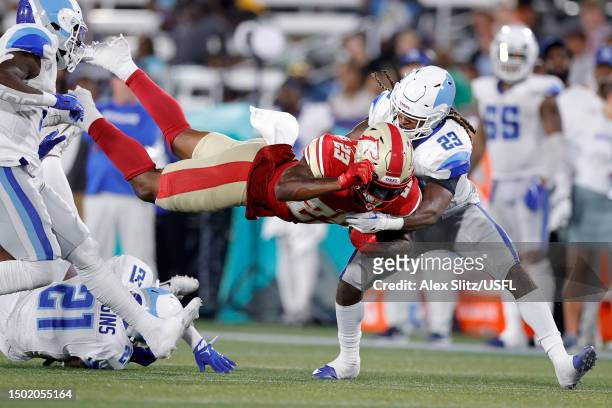 Ricky Person Jr. #23 of the Birmingham Stallions fumbles the ball against Jarey Elder of the New Orleans Breakers during the third quarter in the...