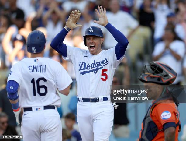 Freddie Freeman of the Los Angeles Dodgers celebrates a two run homerun from Will Smith, to tie the game 4-4 in front of Martin Maldonado of the...