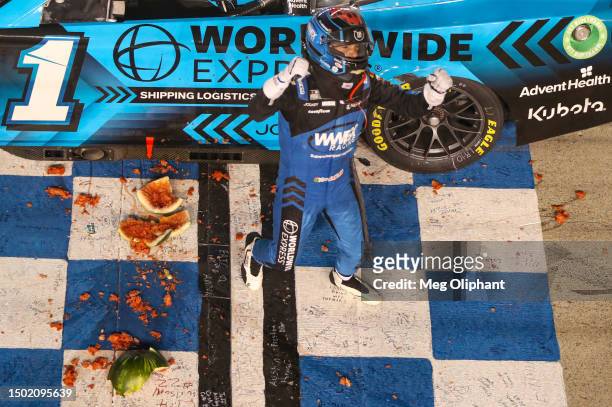 Ross Chastain, driver of the Worldwide Express Chevrolet, celebrates with a watermelon after winning the NASCAR Cup Series Ally 400 at Nashville...