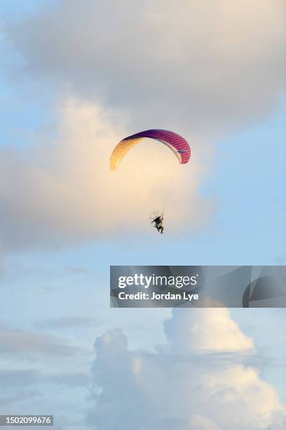 motor paragliding against morning sky - motor paraglider stock pictures, royalty-free photos & images