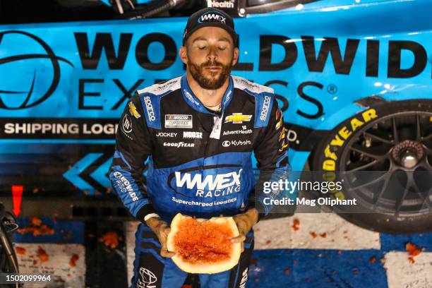 Ross Chastain, driver of the Worldwide Express Chevrolet, celebrates with a watermelon after winning the NASCAR Cup Series Ally 400 at Nashville...