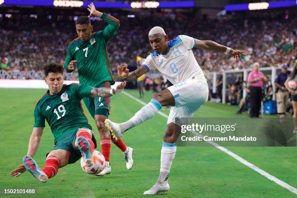 Joseph Rosales of Honduras is defended by Jorge Sánchez of Mexico during the first half of the Concacaf Gold Cup match at NRG Stadium on June 25,...