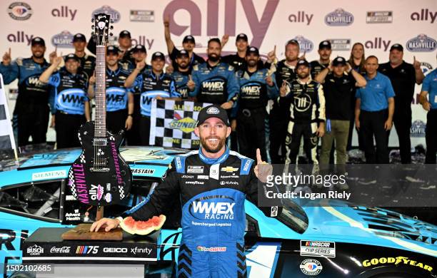 Ross Chastain, driver of the Worldwide Express Chevrolet, and crew celebrate in victory lane after winning the NASCAR Cup Series Ally 400 at...