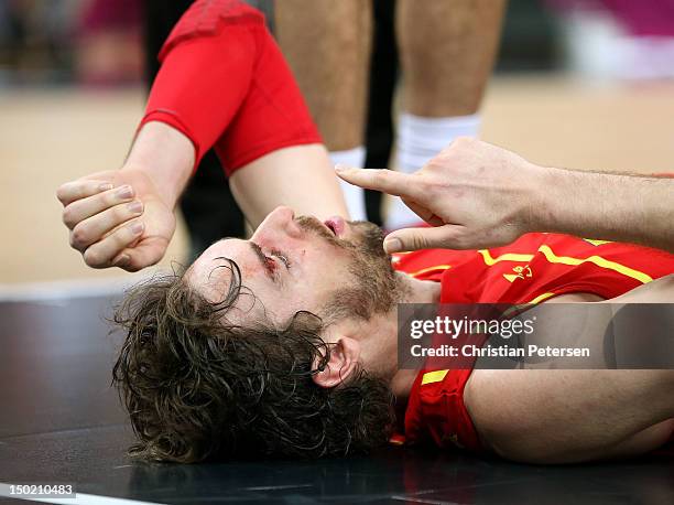 Pau Gasol of Spain lies on the court after he was struck in the face during the Men's Basketball gold medal game between the United States and Spain...