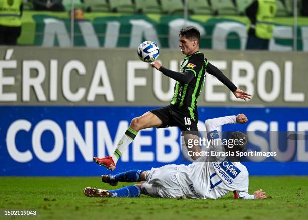 Juan Pablo Vargas of Millonarios battles for the ball with Alexandre Egea of America Mineiro during Copa Conmebol Sul Americana at Independencia...